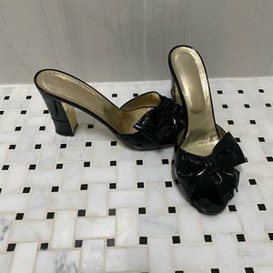 VALENTINO patent bow slides with gold sole and duster bag.